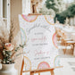 Editable donuts and sprinkles baby shower welcome sign Canva template with watercolour pastel donuts, rainbow sprinkles, and script typography on a soft white background