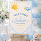 Editable here comes the son baby shower welcome sign Canva template with smiling sun, blue toy airplane, fluffy clouds, arched navy typography, and flowing script on a warm cream background