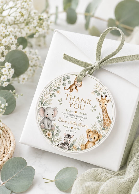 Editable safari baby shower round thank you sticker Canva template with watercolour monkey, giraffe, elephant, lion cub, and zebra in a eucalyptus and tropical leaf wreath on a cream background