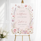 Editable wildflower baby shower welcome sign Canva template with watercolour roses, lavender, cosmos, blush arch, and butterfly details in soft pink and purple tones