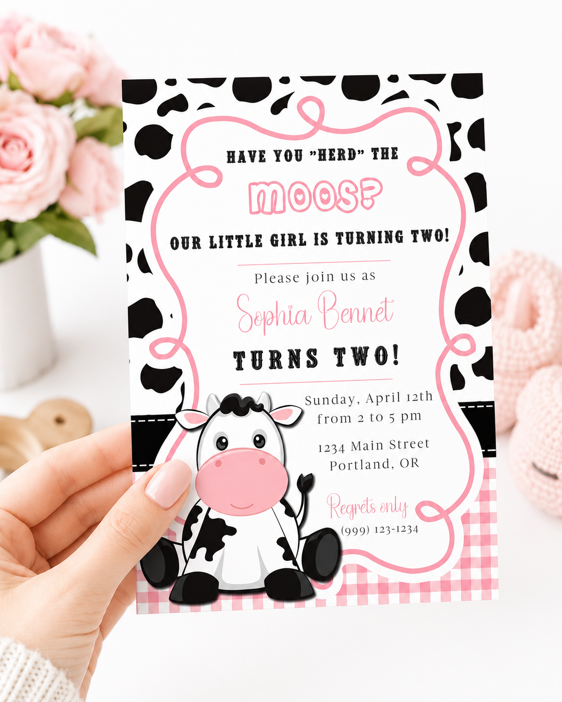 Cow print girl birthday invitation with a cartoon cow, cow spots, and pink gingham in black, white, and pink