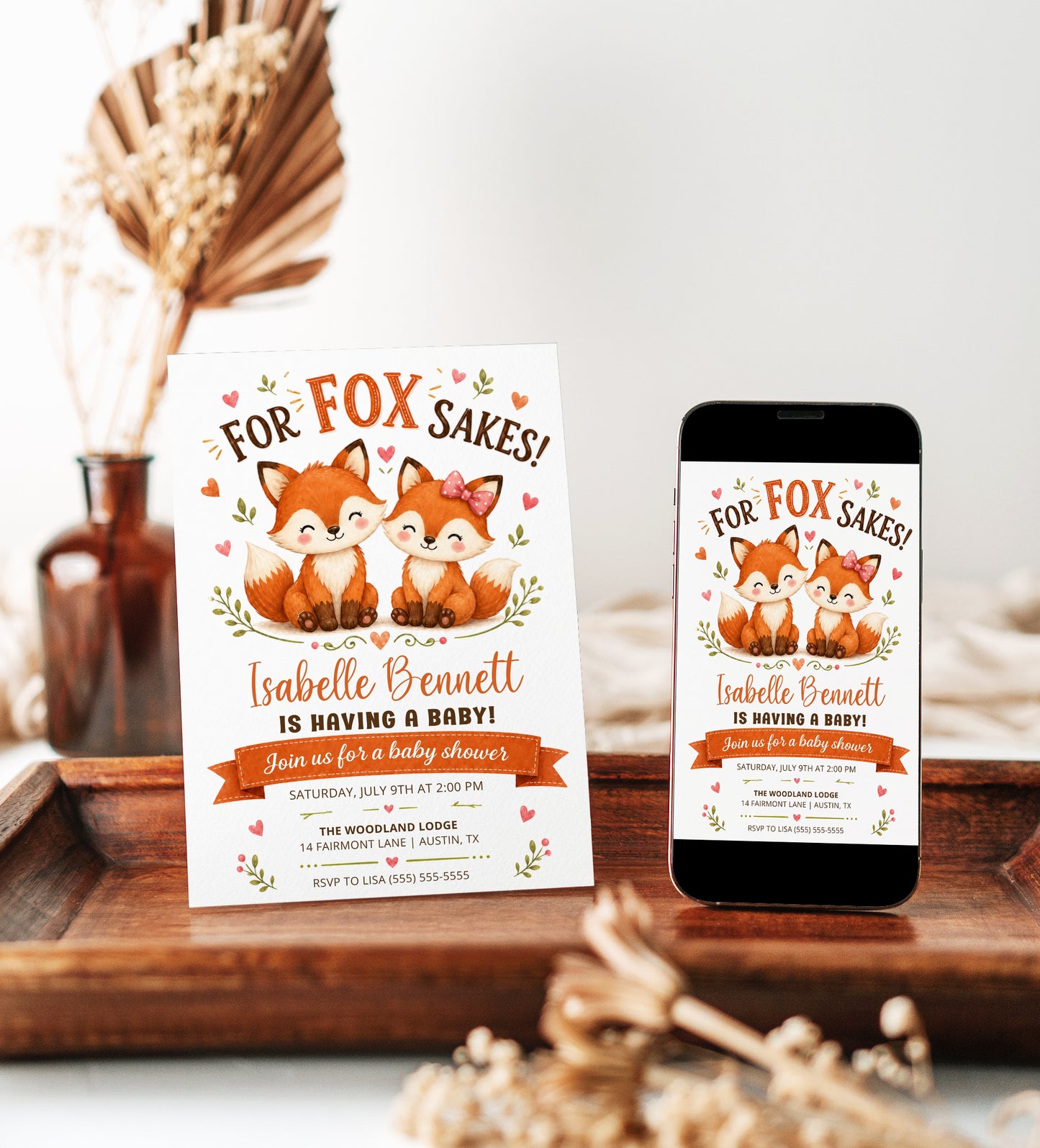 Fox baby shower invitation with two cute baby foxes, leafy greenery, hearts, orange banner, playful woodland details, and warm orange brown accents