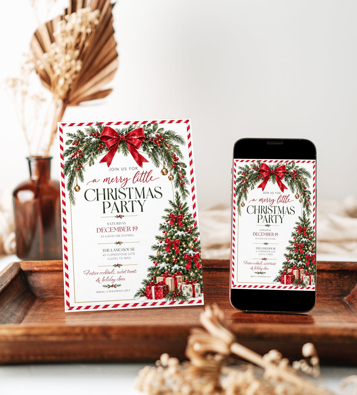 Christmas party invitation with red bows, evergreen garland, holly berries, gold bells, and a decorated Christmas tree