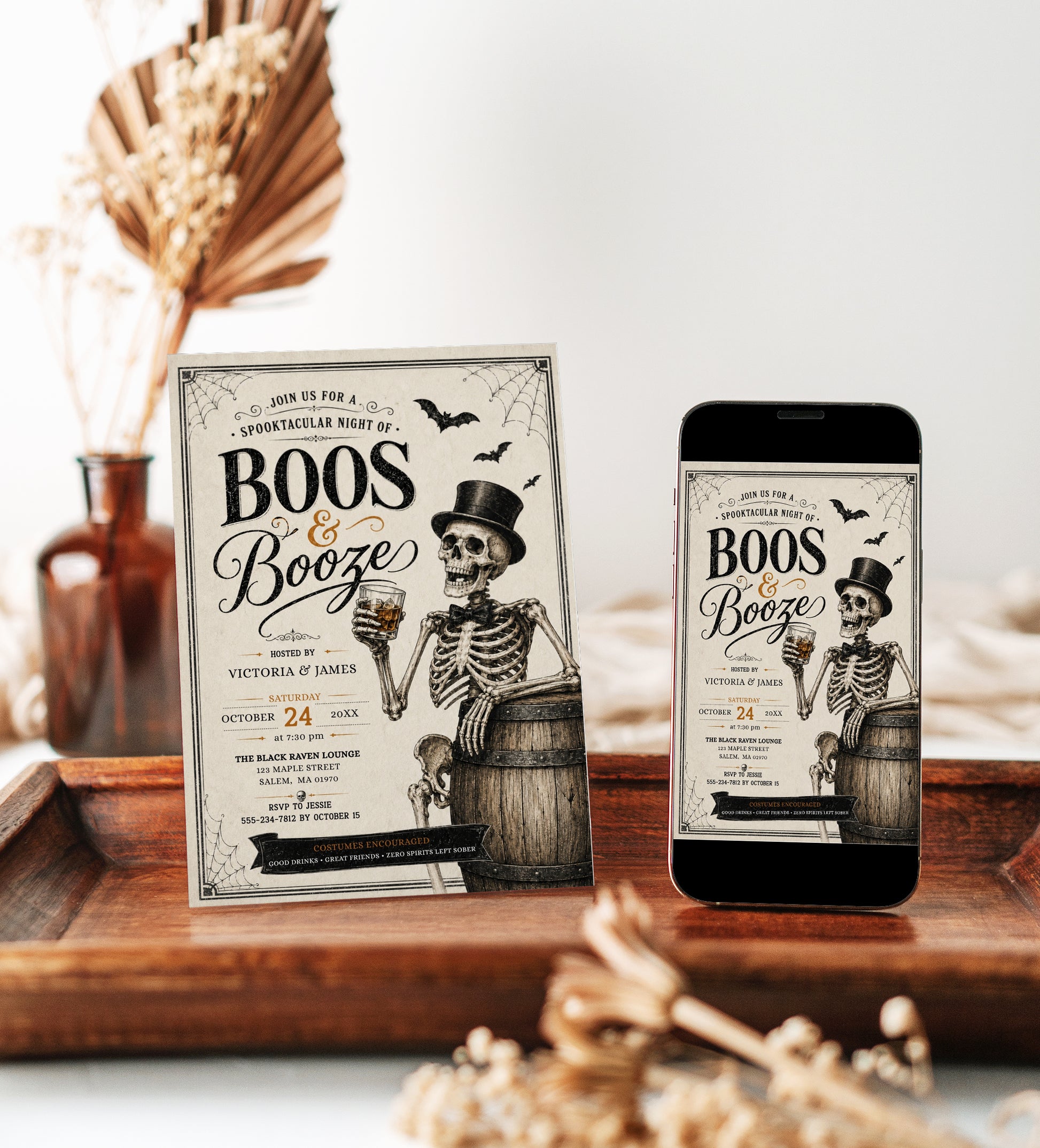 Boos and booze Halloween party invitation with dapper skeleton holding a drink, bats, spiderwebs, vintage typography, barrel, and black gold spooky details
