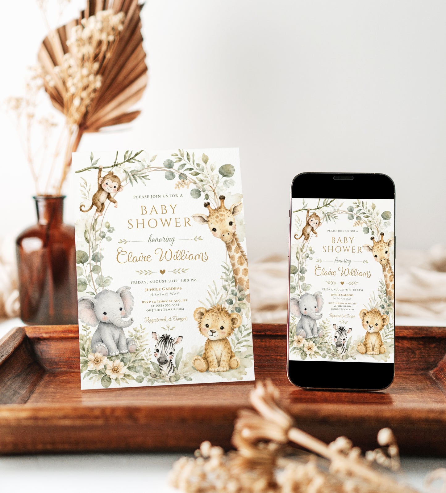 Editable safari baby shower invitation Canva template with watercolour monkey, giraffe, elephant, lion cub, and zebra surrounded by eucalyptus, tropical leaves, and cream wildflowers on a white background
