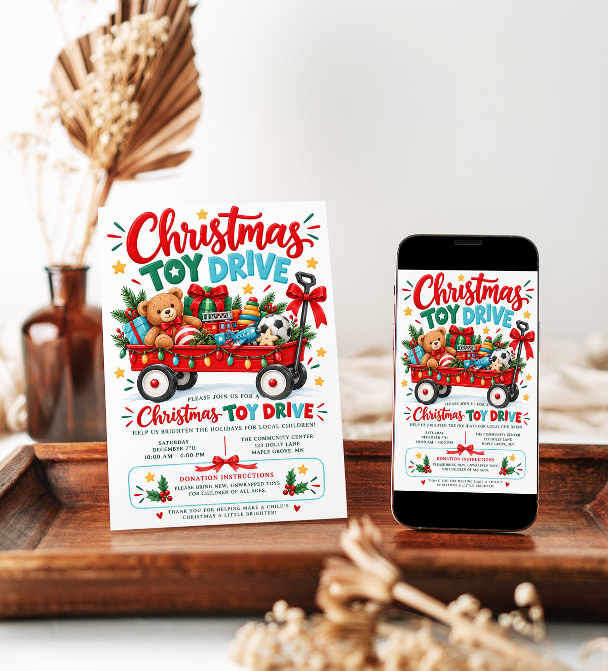 Christmas toy drive invitation with a red wagon filled with wrapped gifts, teddy bear, toy fire truck, colorful lights and festive holiday greenery