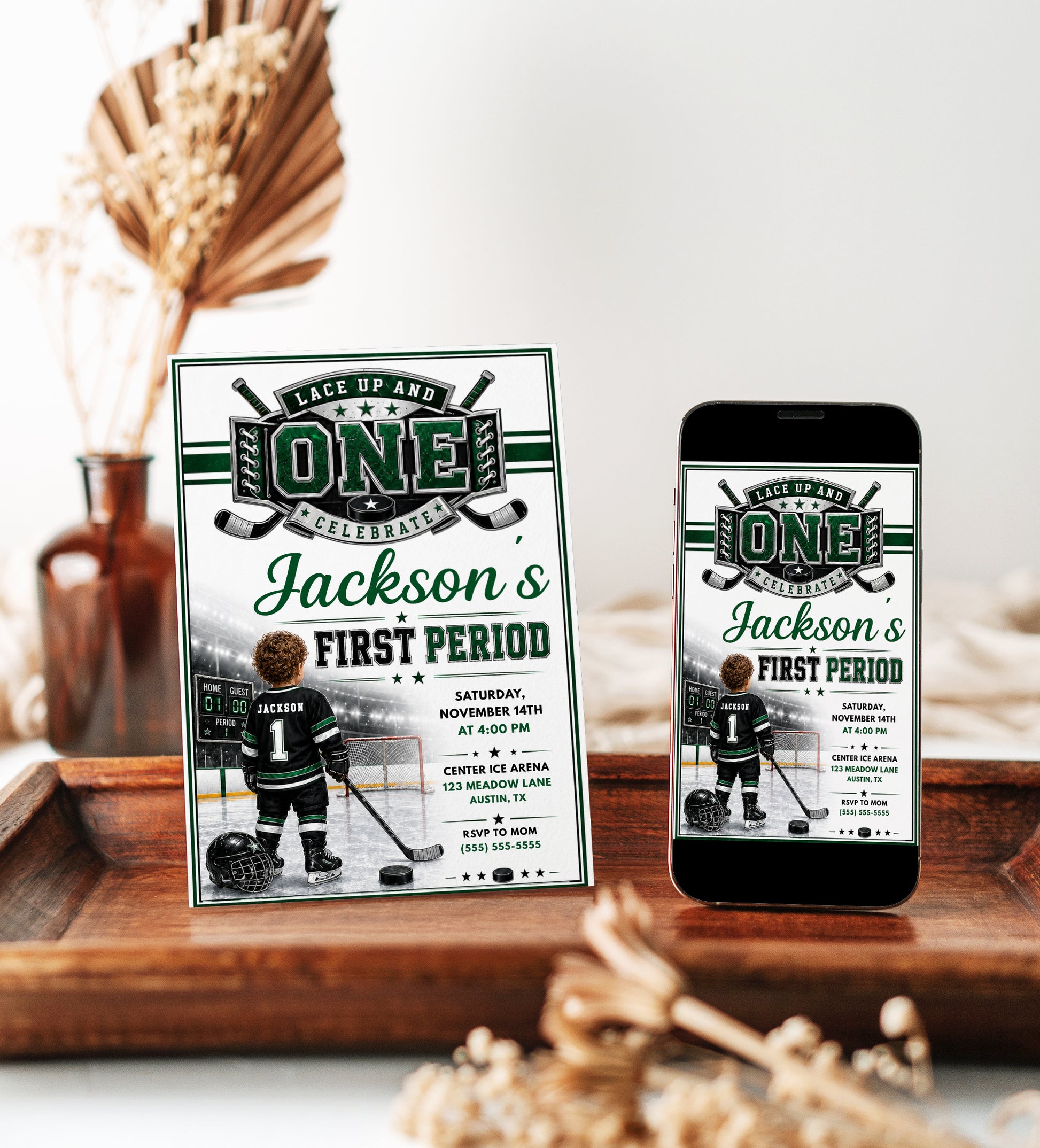 First Period first birthday invitation with little hockey player, ice rink, scoreboard, goal net, hockey stick, puck, and green black sports party details