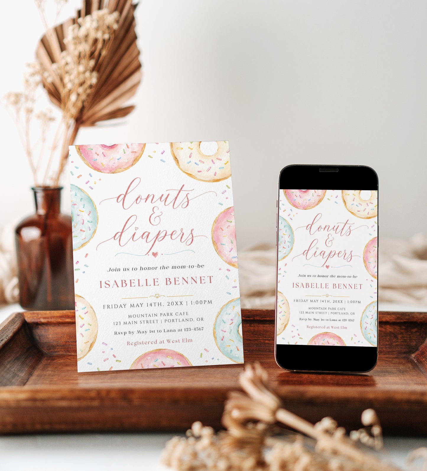 Editable donuts and diapers baby shower invitation Canva template with watercolour pastel donuts, rainbow sprinkles, and script typography on a white background