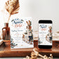 Après Bébé baby shower invitation with wooden skis, a rustic sled, knit baby hat and mittens, hot cocoa, snowy mountains, and evergreen branches