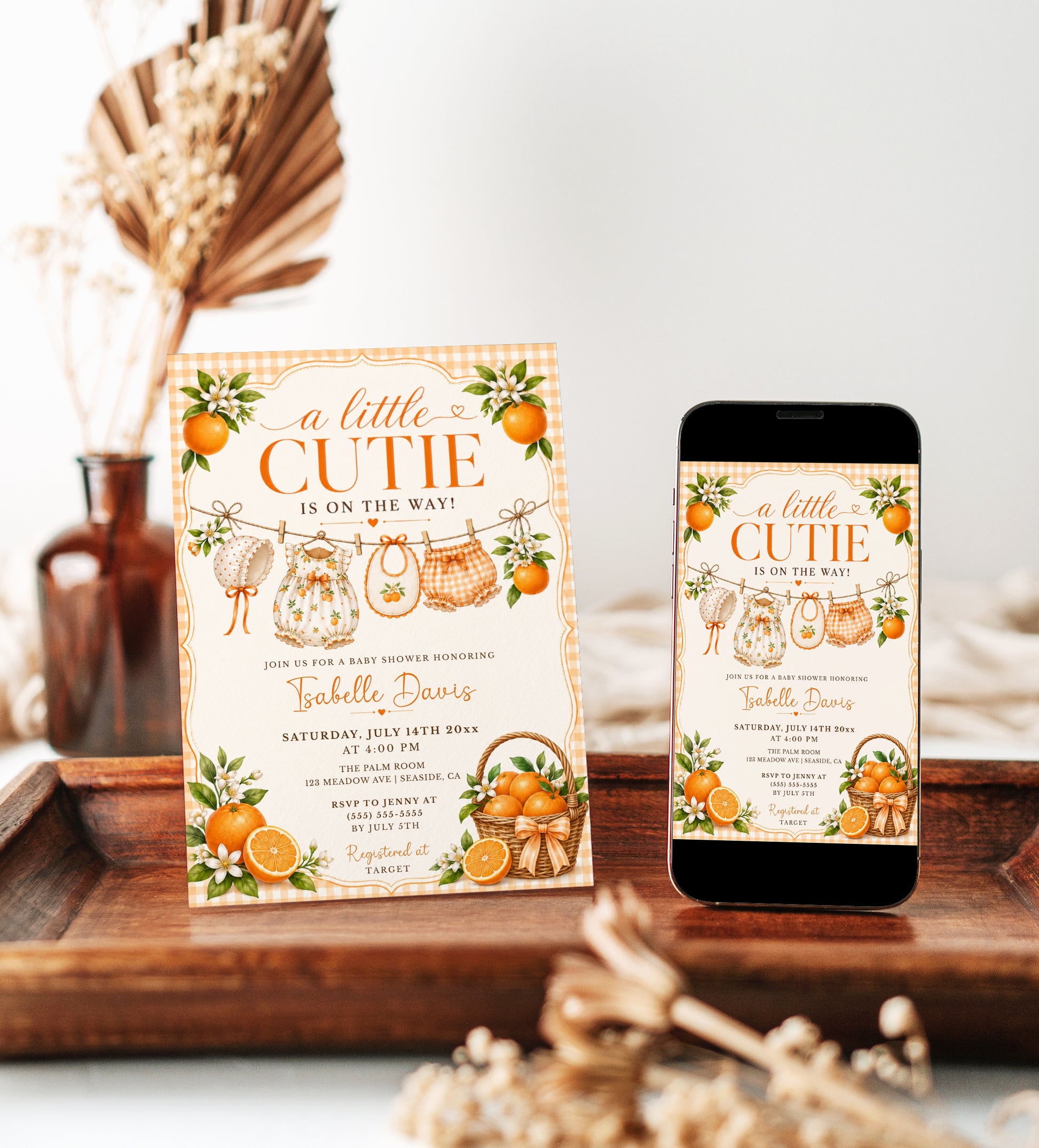 Editable little cutie baby shower invitation Canva template with watercolour oranges, orange blossoms, wicker fruit basket, clothesline scene with romper and bonnet, and orange gingham background
