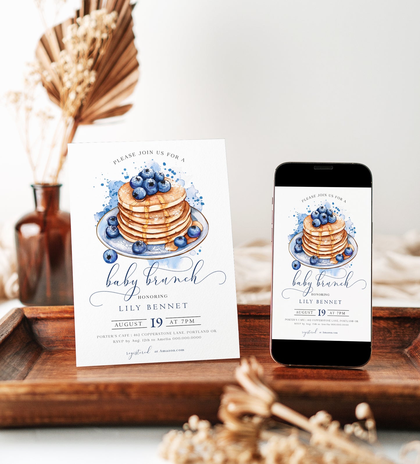 Blueberry baby brunch invitation with a watercolor stack of pancakes, syrup, and blueberries in blue and white