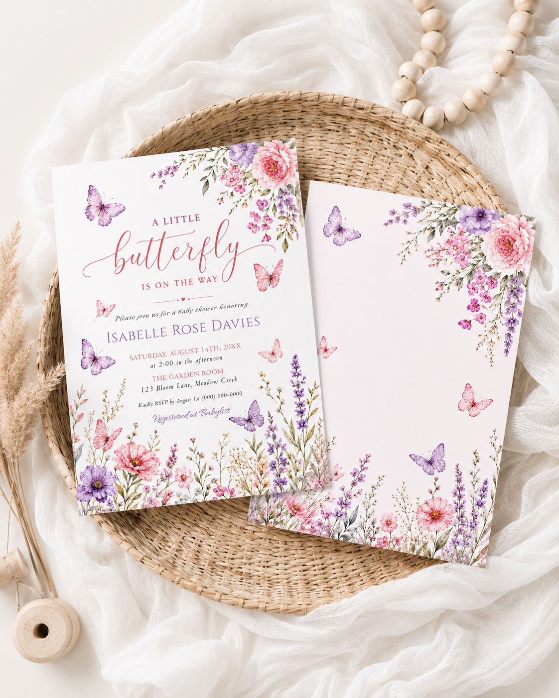 Editable pink and purple butterfly baby shower invitation Canva template with watercolour peonies, lavender, cosmos, and butterfly details on a soft blush background, shown with front and back of card