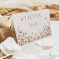Editable wildflower folded thank you card Canva template with watercolour roses, lavender, daisies, and butterfly details on a white background, shown as a folded card mockup