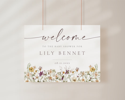 Horizontal wildflower baby shower welcome sign template with watercolor meadow flowers in yellow, purple, and cream, editable in Canva