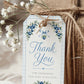 Editable blueberry baby shower favor hang tag Canva template with watercolour blueberry clusters, white blossoms, blue ribbon bow, and script typography on a cream background with blue gingham border