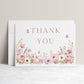 Editable wildflower folded thank you card Canva template with watercolour roses, lavender, daisies, and butterfly details on a white background, shown as a folded card mockup