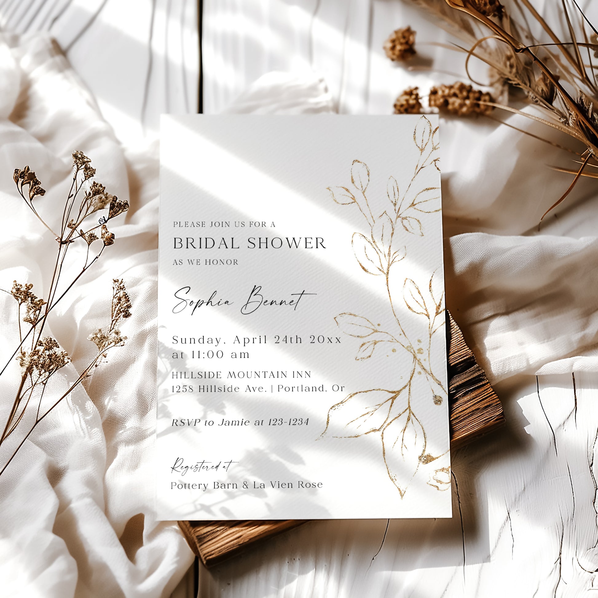 Elegant gold leaf bridal shower invitation template with hand-painted gold botanical branch on white background, editable in Canva