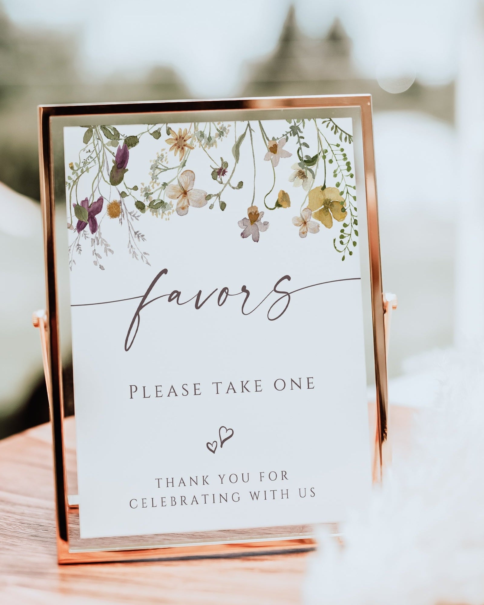 Wildflower baby shower favors sign template with watercolor meadow flowers in yellow, purple, and cream with calligraphy script, editable in Canva