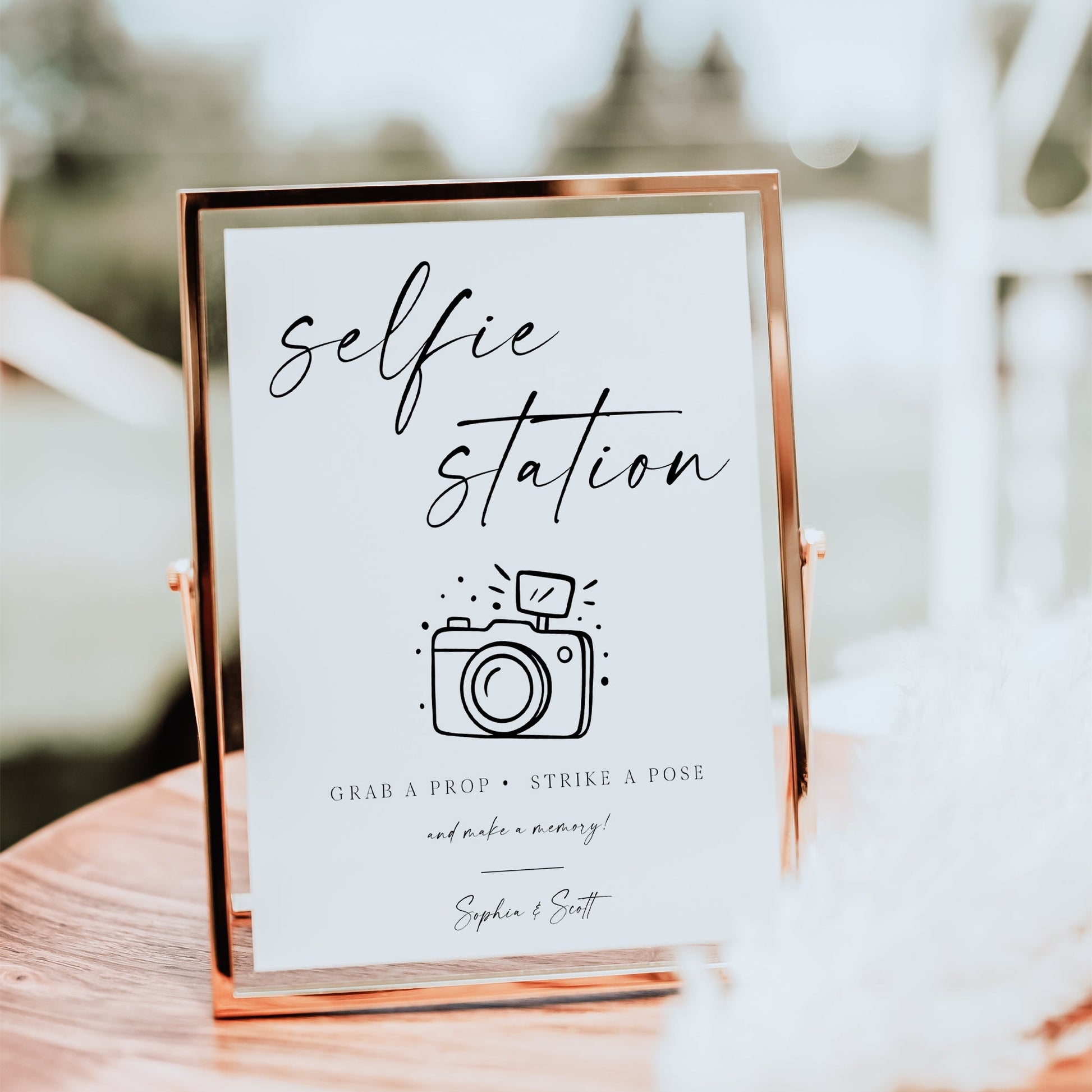 Minimalist black and white wedding selfie station sign template with calligraphy script and hand-drawn camera illustration, editable in Canva