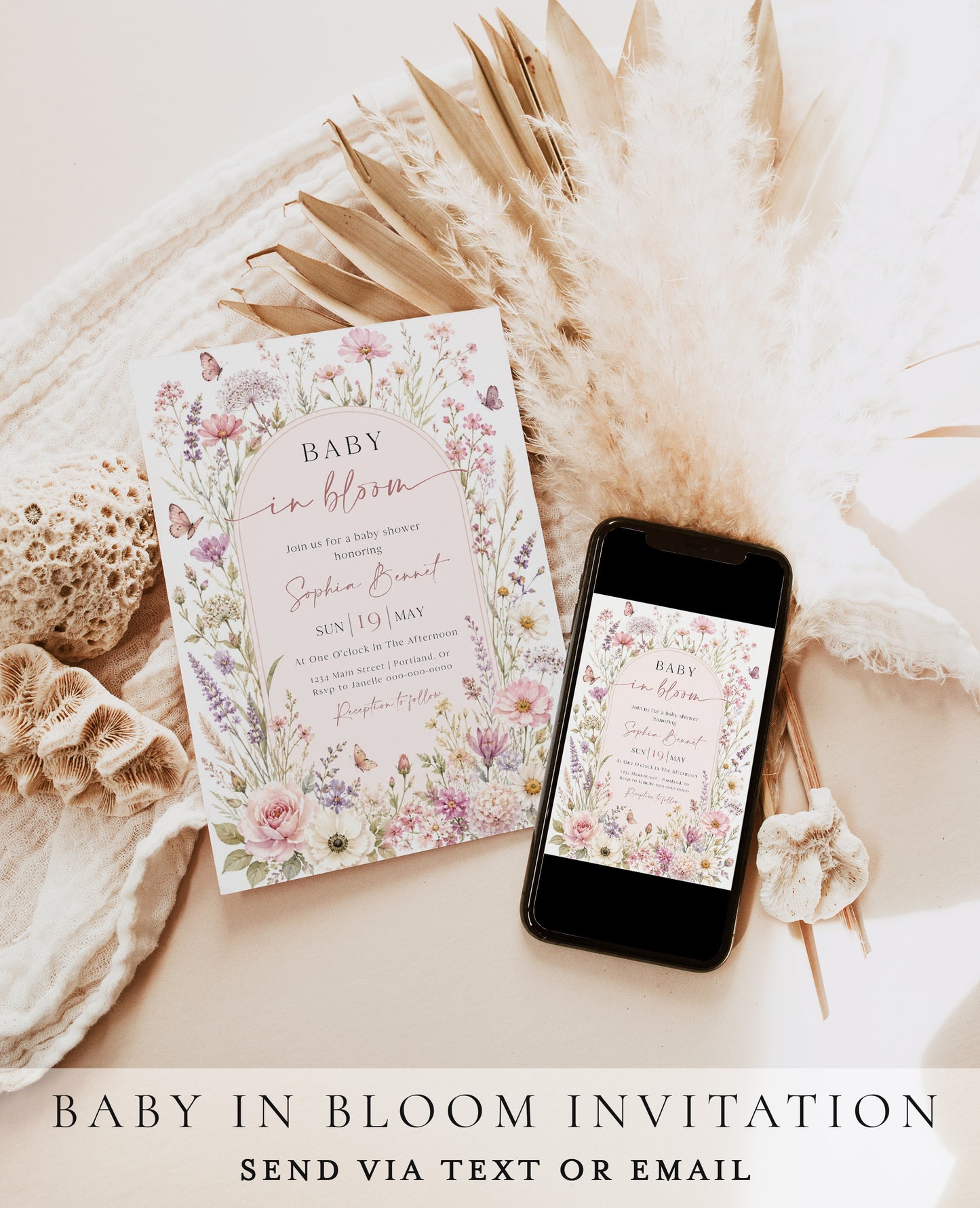 Editable baby in bloom wildflower baby shower invitation Canva template with watercolour roses, cosmos, lavender, and butterfly details framing a blush arch, shown with front and back of card