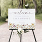 Horizontal wildflower baby shower welcome sign template with watercolor meadow flowers in yellow, purple, and cream, editable in Canva