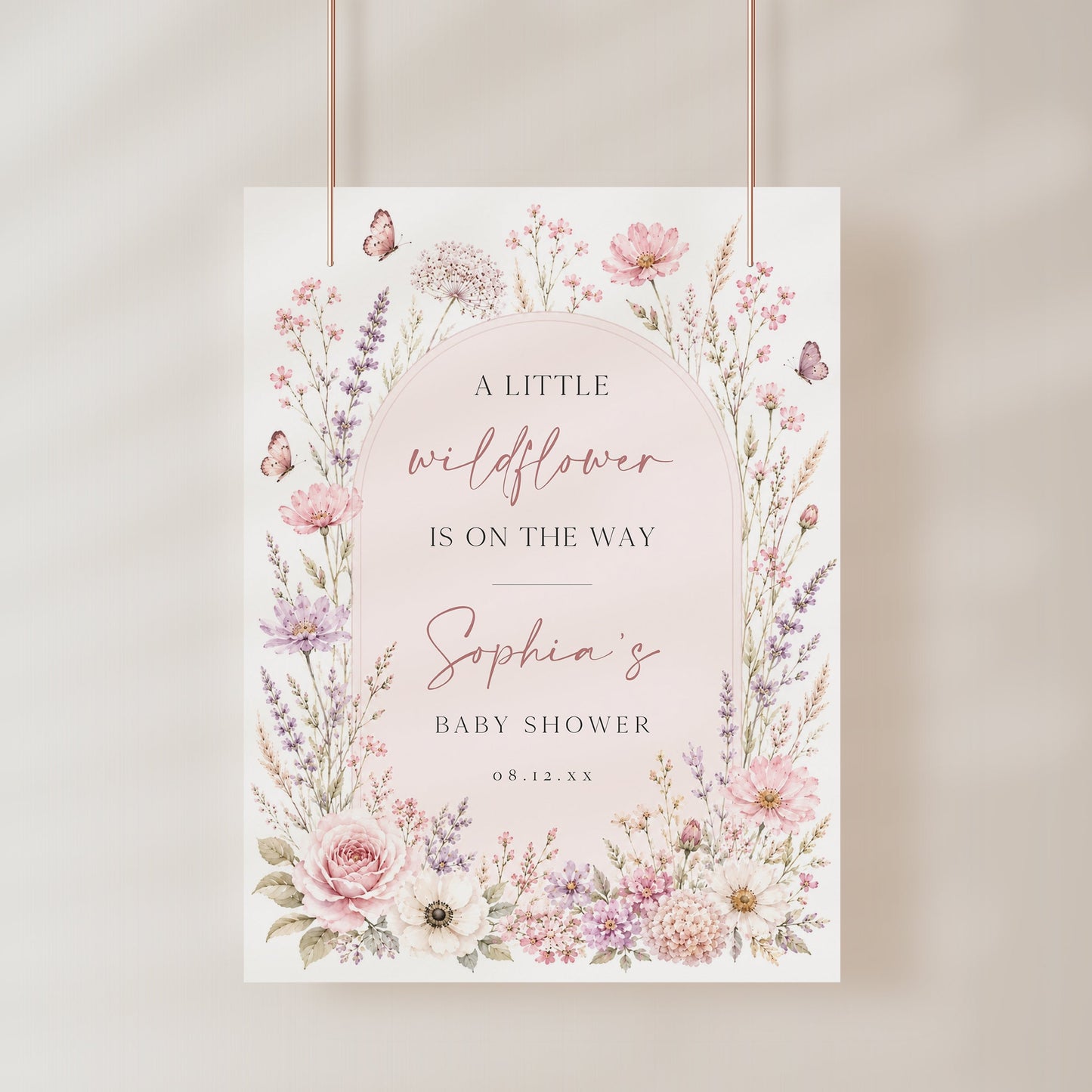 Editable wildflower baby shower welcome sign Canva template with watercolour roses, lavender, cosmos, blush arch, and butterfly details in soft pink and purple tones