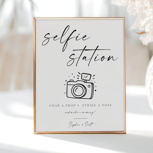 Minimalist black and white wedding selfie station sign template with calligraphy script and hand-drawn camera illustration, editable in Canva
