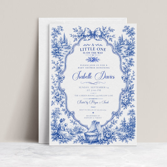 Blue toile baby shower invitation with ornate floral frame, bow, baby carriage, rocking horse, countryside scene, and elegant royal blue vintage details
