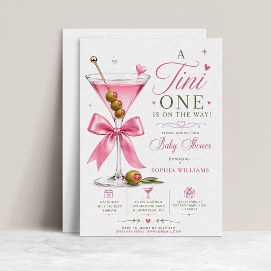 Editable martini baby shower invitation Canva template with pink martini glass, satin bow, heart-topped olive garnish, sparkle accents, and playful pink and olive green typography on a white background