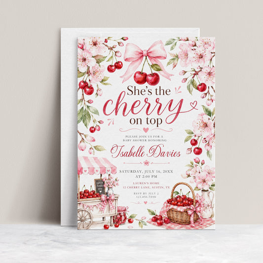 Cherry baby shower invitation featuring red cherries, pink cherry blossoms, blush gingham bows, cherry cart, basket and floral details.

