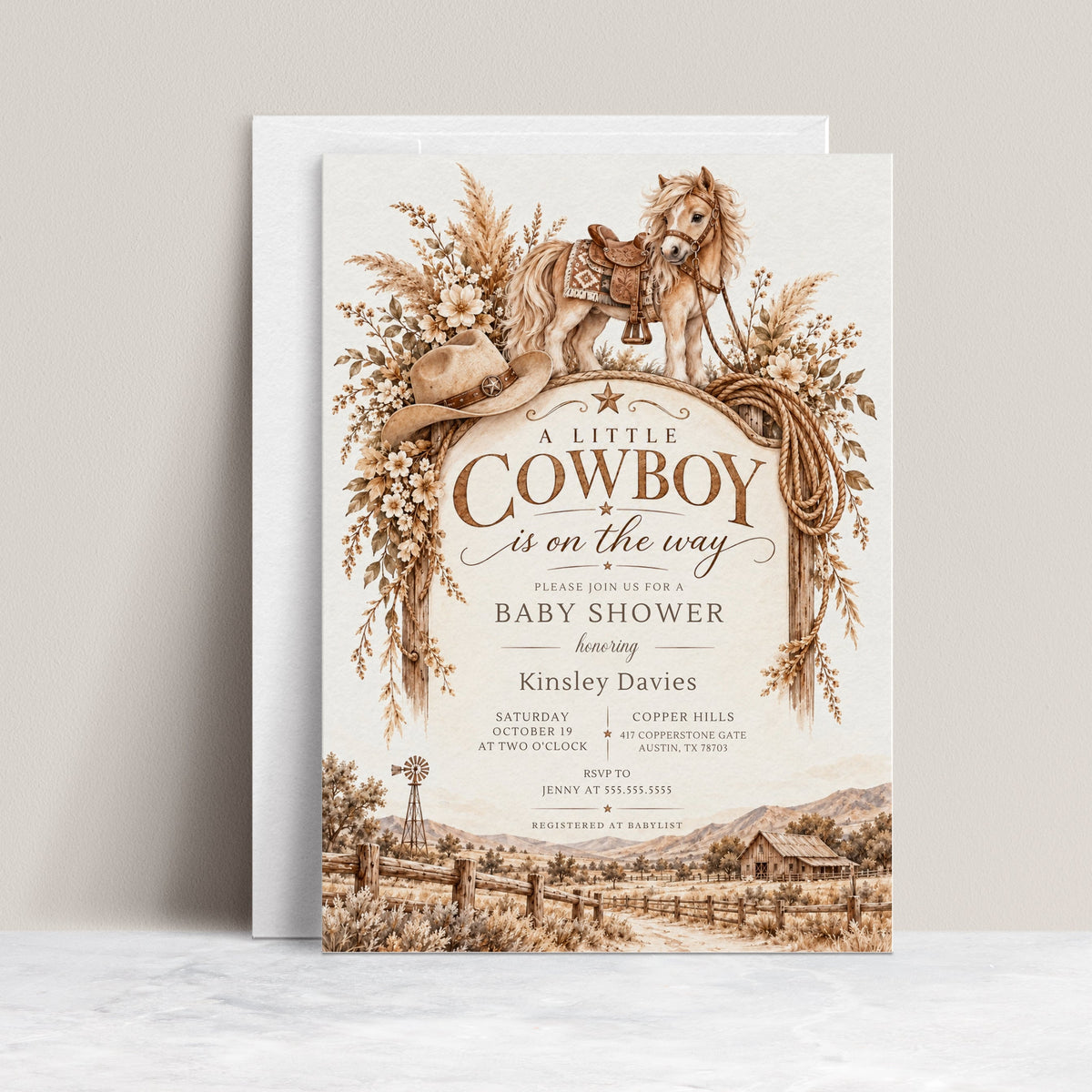 Cowboy baby shower invitation with a saddled horse, cowboy hat, lasso, dried florals, and rustic ranch scene in brown and cream for a western baby boy shower