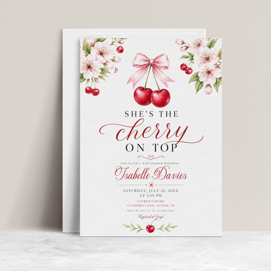Cherry baby shower invitation with watercolor cherries, pink cherry blossoms, leafy branches, pink bow, elegant script lettering, and clean white background