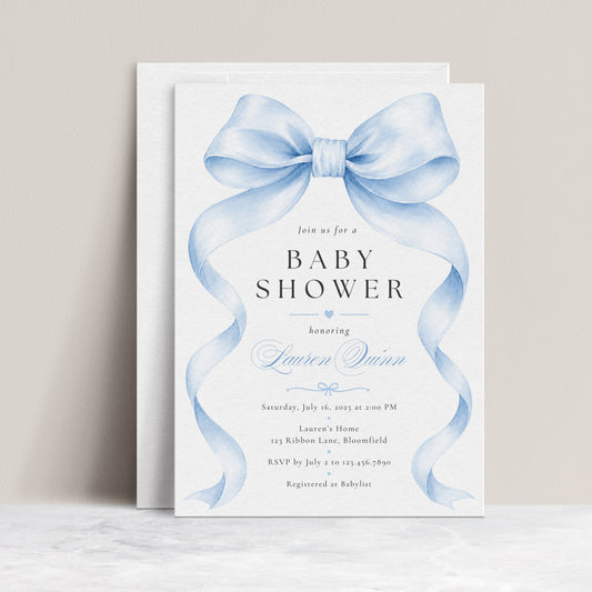 Editable blue bow baby boy shower invitation Canva template with oversized watercolour powder blue bow and flowing ribbon tails, bold spaced serif typography, and blue calligraphy script on a white background