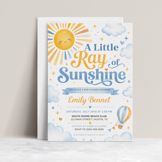 A little ray of sunshine baby shower invitation with golden sun, soft blue clouds, stars, hearts, and a blue and yellow hot air balloon