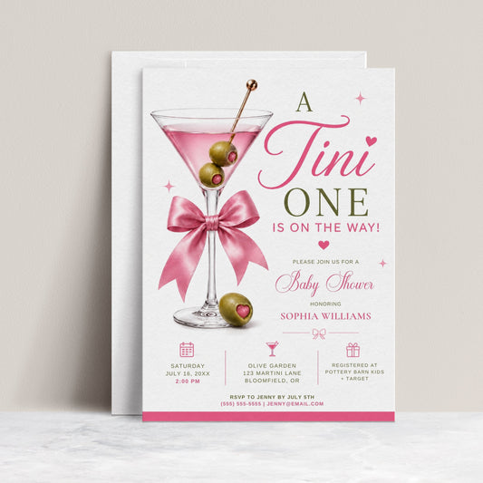 Editable martini baby shower invitation Canva template with pink martini glass, satin bow, heart-topped olive garnish, sparkle accents, and playful pink and olive green typography on a white background