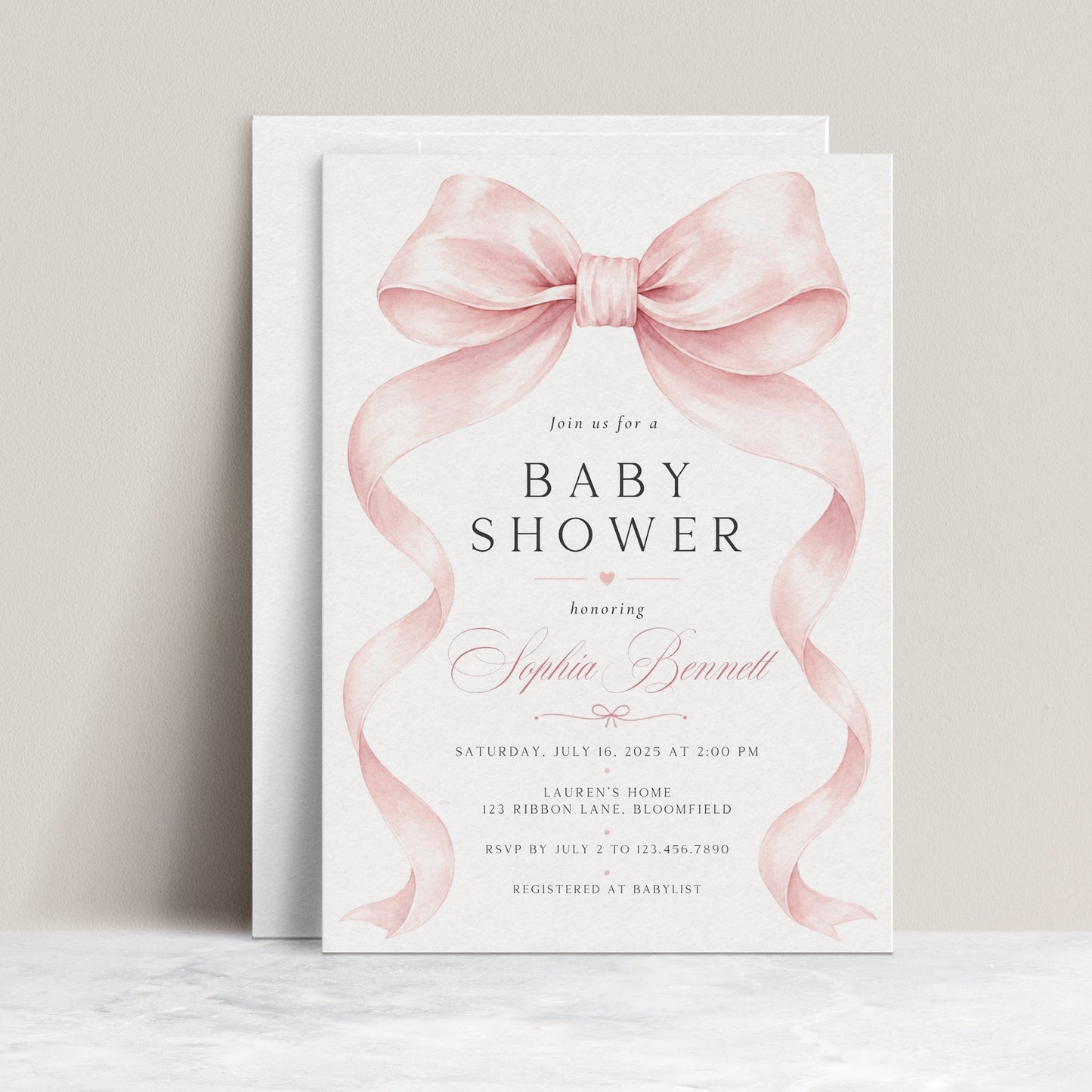 Editable pink bow baby shower invitation Canva template with oversized watercolour blush bow and flowing ribbon tails, bold spaced serif typography, and italic script on a soft blush background