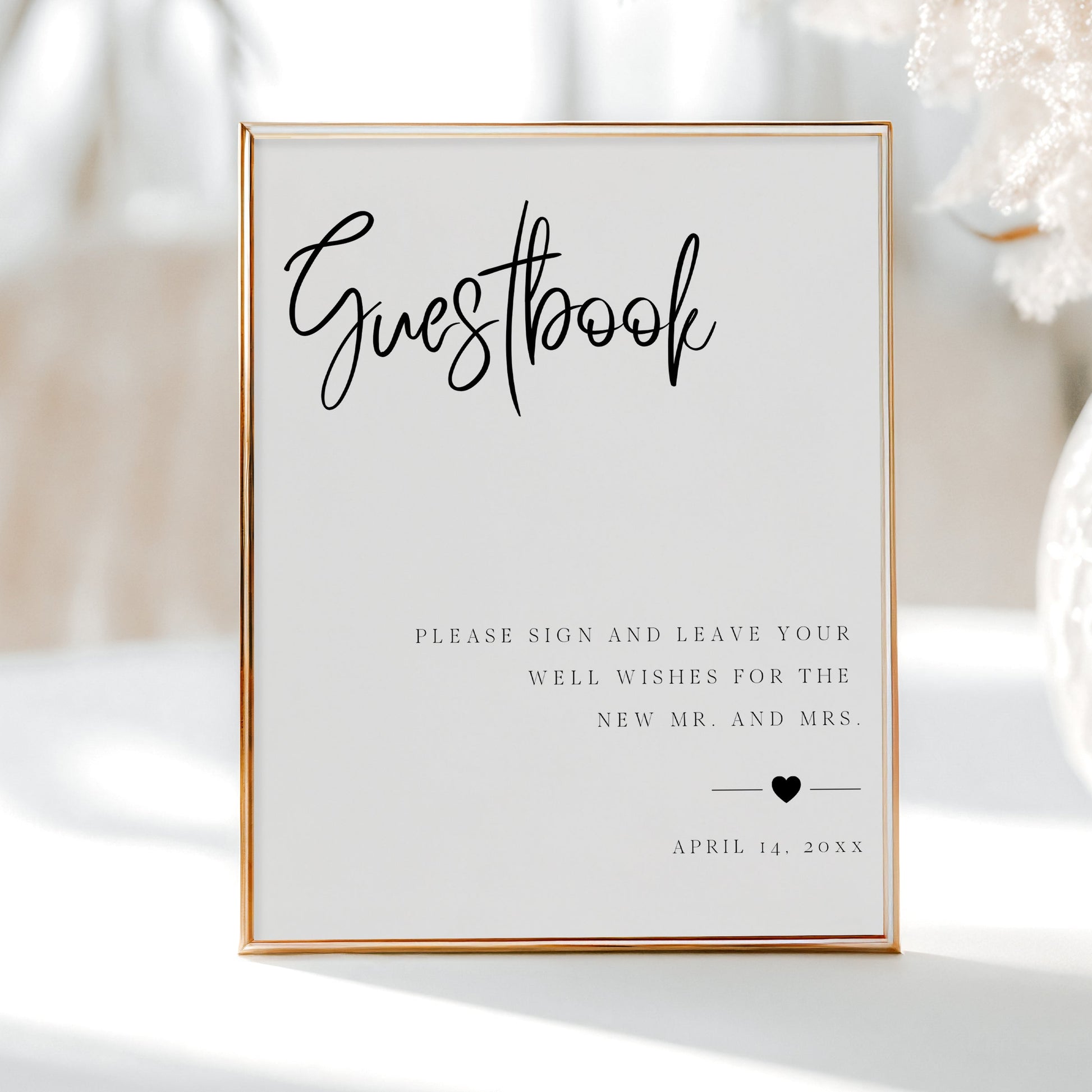 Minimalist black and white wedding guestbook sign template with bold calligraphy script and elegant spaced typography, editable in Canva