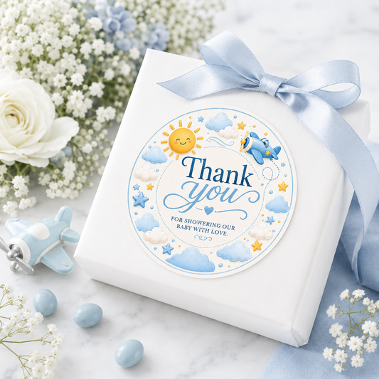 Editable here comes the son baby shower round thank you sticker Canva template with smiling sun, blue toy airplane, fluffy clouds, and gold and blue star accents on a cream background