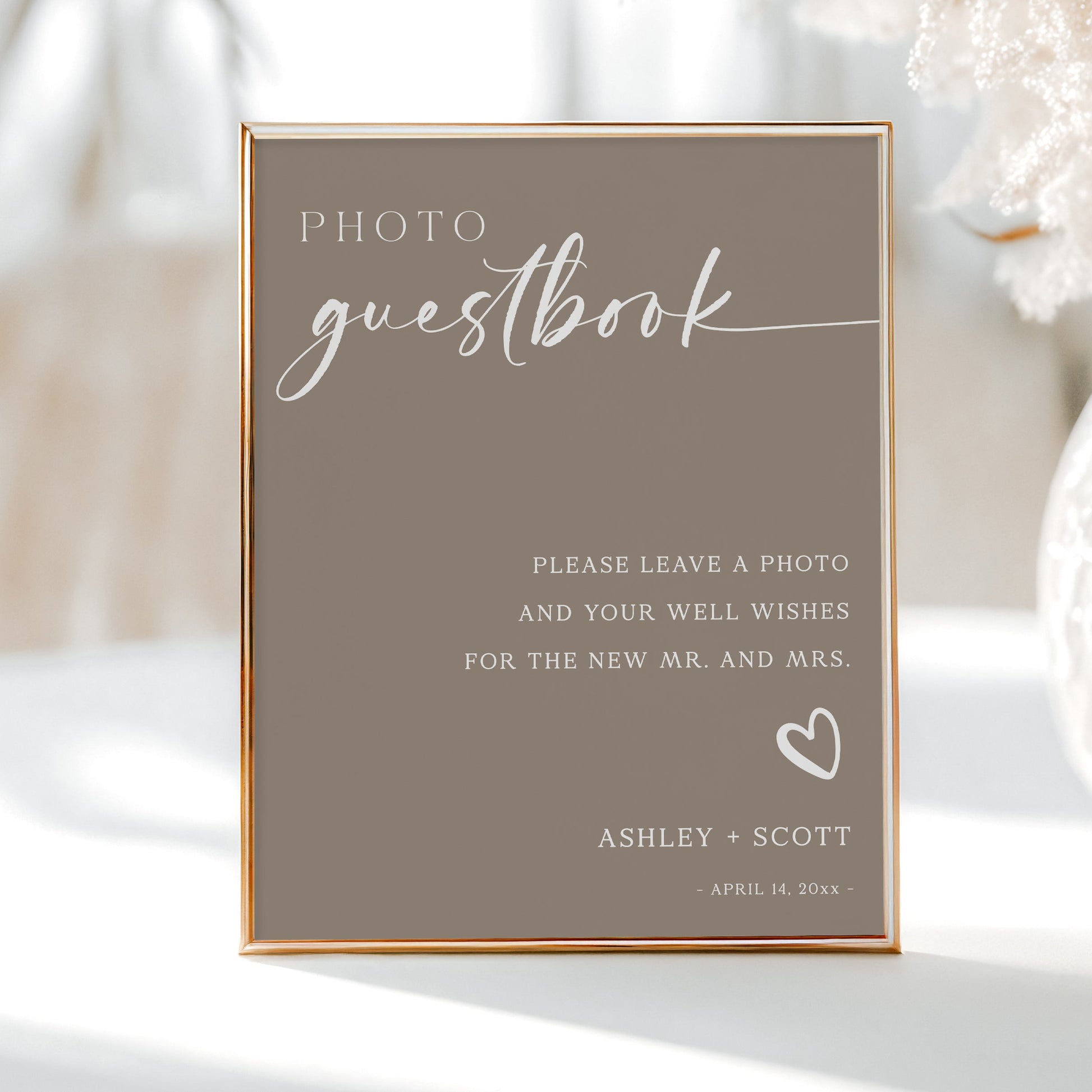 Photo guestbook sign with elegant white script on beige background, includes heart accent and space for couple’s names and date | Editable template via Corjl | www.foreveryourprints.com