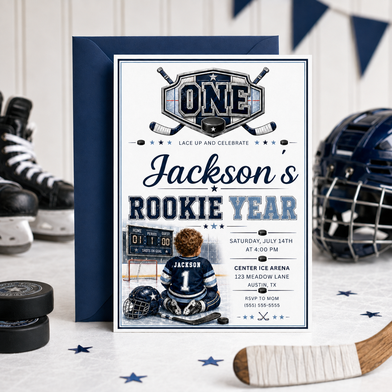 Rookie Year first birthday invitation with little hockey player, ice rink, scoreboard, helmet, hockey sticks, puck, and navy blue birthday party details